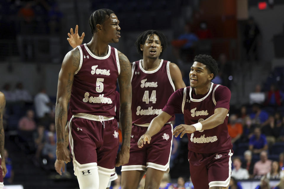 Texas Southern forward Joirdon Karl Nicholas (5) celebrates with forward Brison Gresham (44) and guard PJ Henry (3) after playing against Florida during the first half of an NCAA college basketball game Monday, Dec. 6, 2021, in Gainesville, Fla. (AP Photo/Matt Stamey)