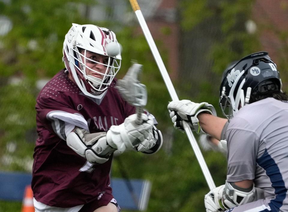 La Salle attacker Garrett Clare takes a shot against Quaker defender Henry Alessandro in the first half.