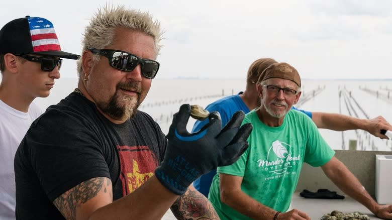 Guy Fieri holds oyster