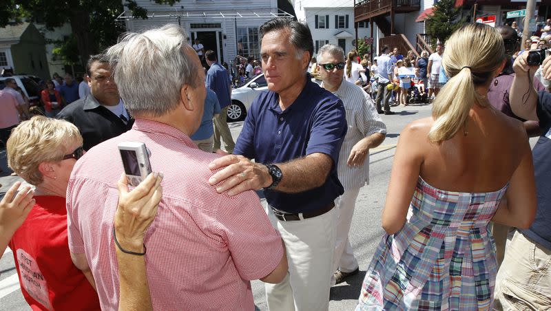 Former Republican presidential candidate Mitt Romney walks in the Fourth of July Parade in Wolfeboro, N.H., on July 4, 2012.