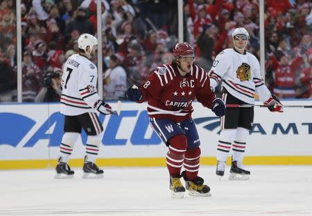 Jan 1, 2015; Washington, DC, USA; Washington Capitals left wing Alex Ovechkin (8) celebrates a goal by right wing Troy Brouwer (not pictured) against the Chicago Blackhawks in the third period during the 2015 Winter Classic hockey game at Nationals Park. Mandatory Credit: Geoff Burke-USA TODAY Sports