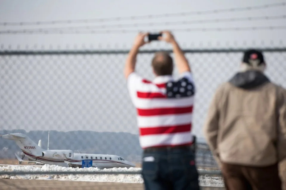 In this Jan. 24, 2016 file photo, a man photographs the plane carrying then-Republican presidential candidate Donald Trump as it departs Muscatine Municipal Airport after he spoke in Muscatine, Iowa. AP