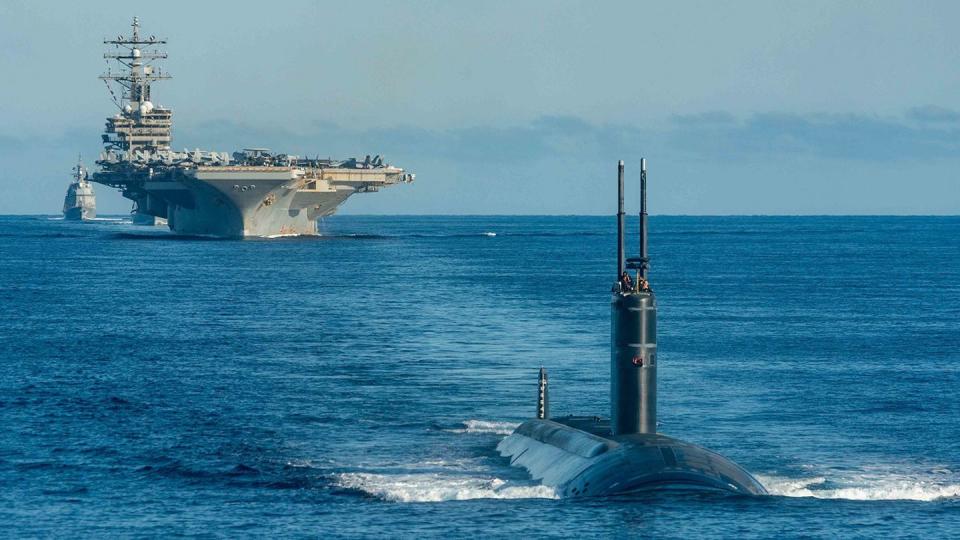 A U.S. fast-attack submarine steams ahead of the aircraft carrier Ronald Reagan and ships with the Korean navy and Japan Maritime Self-Defense Force during a tri-lateral anti-submarine warfare exercise off the Korean Peninsula Sept. 30. (MC3 Gray Gibson/Navy)