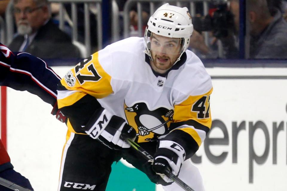 The English Ice Hockey Association announced Monday that it would be mandating neck protection after former NHL player Adam Johnson, seen above in 2017 with the Pittsburgh Penguins, died in a game after being cut by a skate on Saturday.