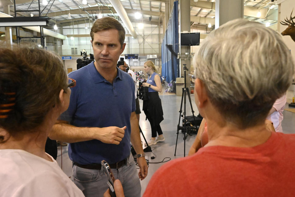 FILE - Kentucky Governor Andy Beshear, center, answers question from residents of Knott County Ky., that have been displaced by floodwaters at the Knott County Sportsplex in Leburn, Ky., July 31, 2022. (AP Photo/Timothy D. Easley, File)