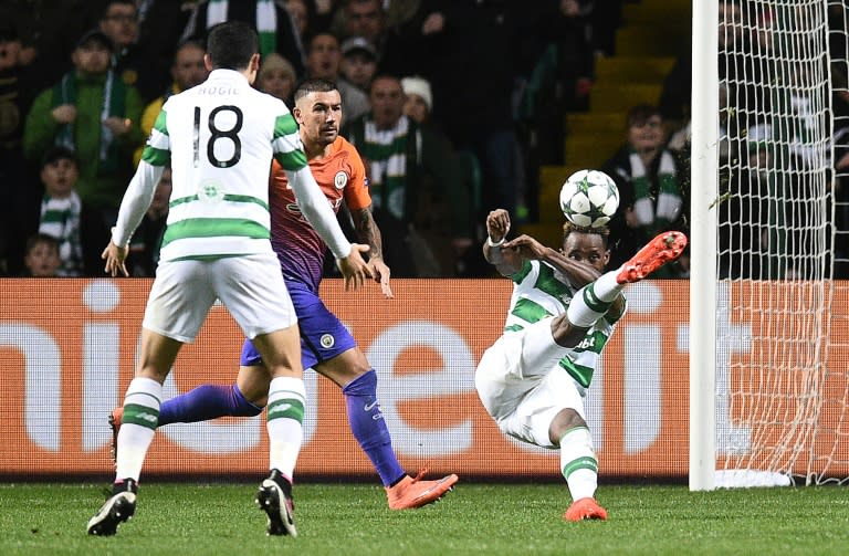 Manchester City's defender Aleksandar Kolarov (2L) watches as Celtic's striker Moussa Dembele (R) scores his team's thrid goal during the UEFA Champions League Group C football match between Celtic and Manchester City on September 28, 2016