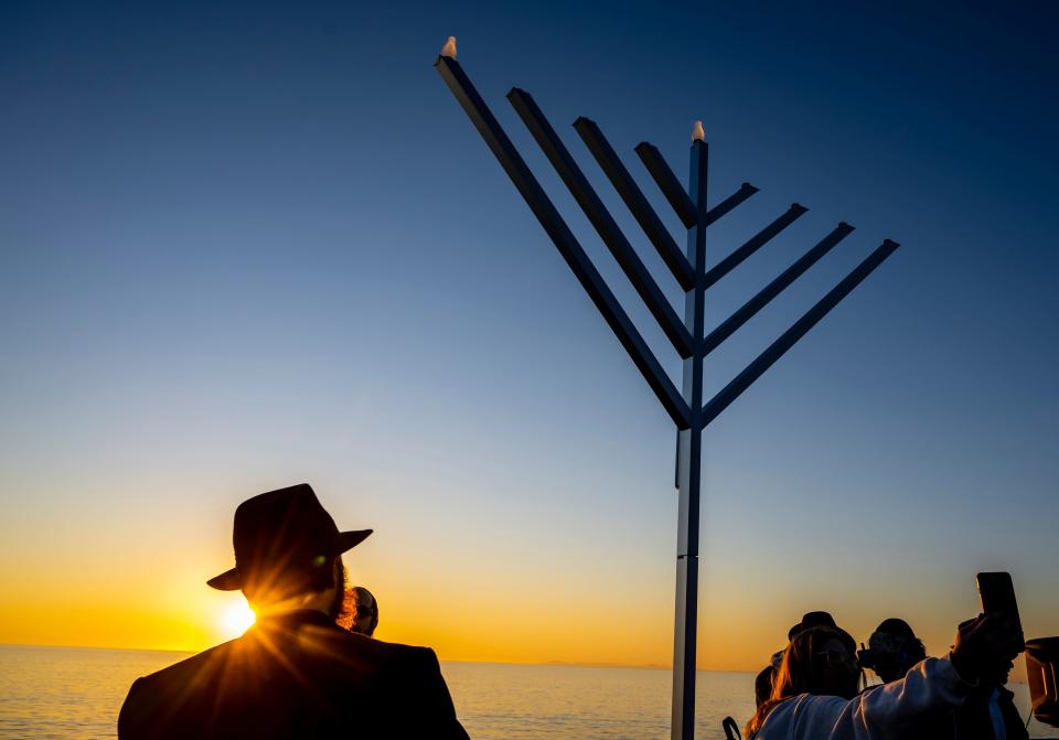 Chabad of San Clemente prepares to light the menorah after the sun sets during "Chanukah on the Pier" event at the end of the San Clemente pier in San Clemente, Calif., on Dec. 18, 2022.