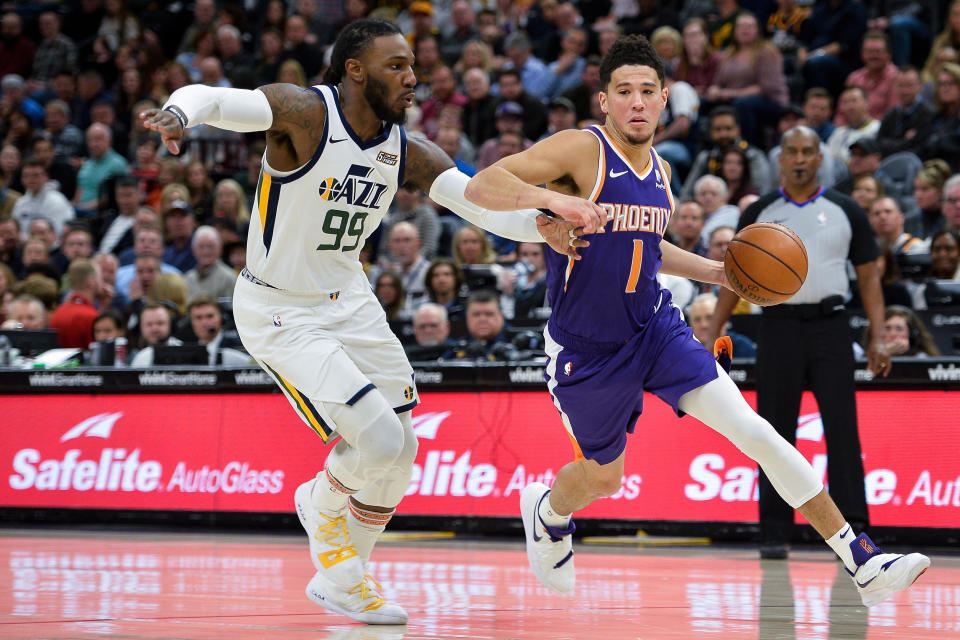 SALT LAKE CITY, UT - MARCH 25: Devin Booker #1 of the Phoenix Suns drives past Jae Crowder #99 of the Utah Jazz during a game at Vivint Smart Home Arena on March 25, 2019 in Salt Lake City, Utah. NOTE TO USER: User expressly acknowledges and agrees that, by downloading and or using this photograph, User is consenting to the terms and conditions of the Getty Images License Agreement. (Photo by Alex Goodlett/Getty Images)