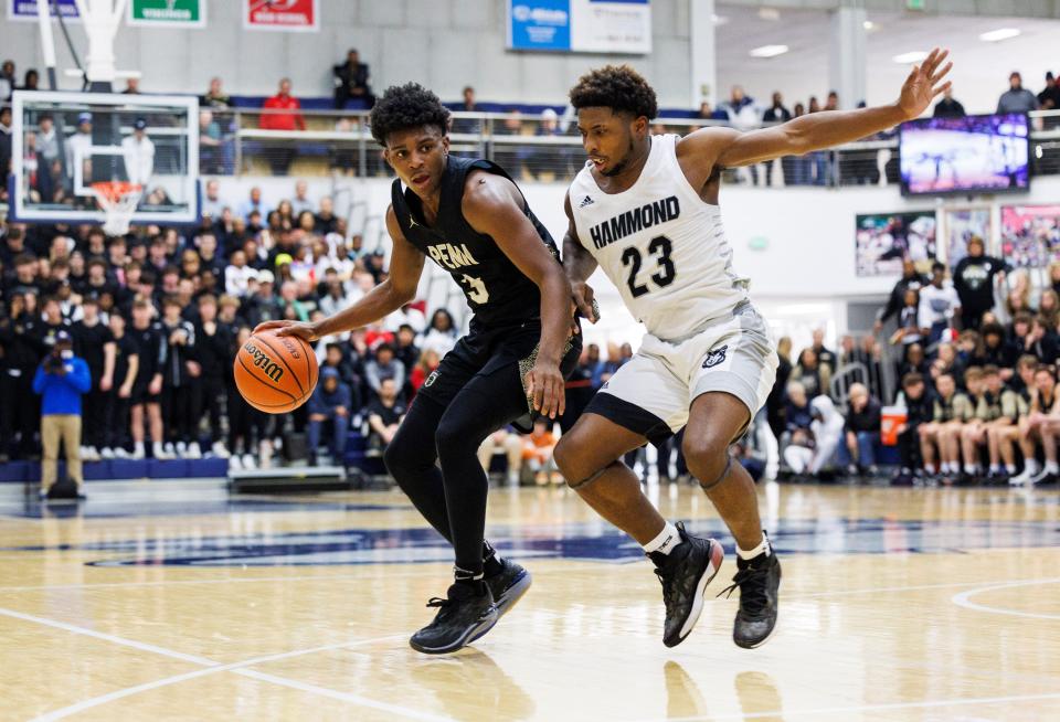 Penn's Markus Burton (3) drives to the basket as Hammond Central's Kenneth Grant (23) defends during the Penn-Hammond Central high school 4A Semi-State Semi-Final basketball game on Saturday, March 18, 2023, at Michigan City High School in Michigan City, Indiana.