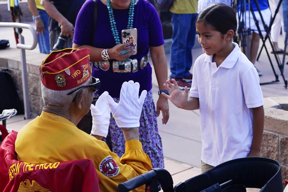 Navajo Code Talker Thomas Begay, left, waves prior to the Arizona State Navajo Code Talkers Day celebration, Sunday, Aug. 14, 2022, in Phoenix. (AP Photo/Ross D. Franklin)