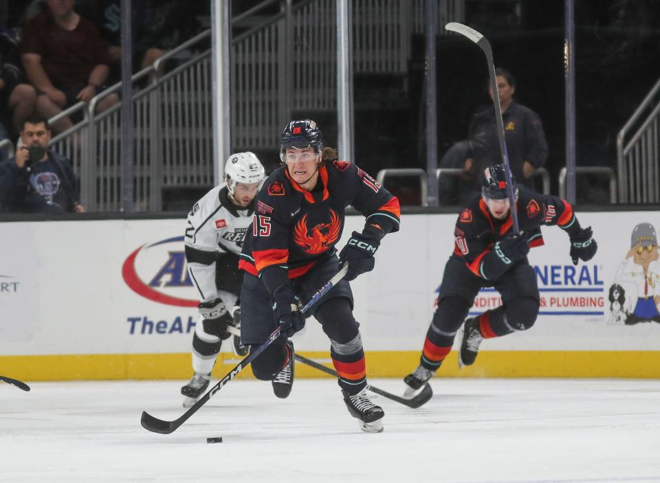 John Hayden, 15, of the Coachella Valley Firebirds brings the puck up the ice against the Ontario Reign at Acrisure Arena in Palm Desert, Calif., Feb. 20, 2023. 
