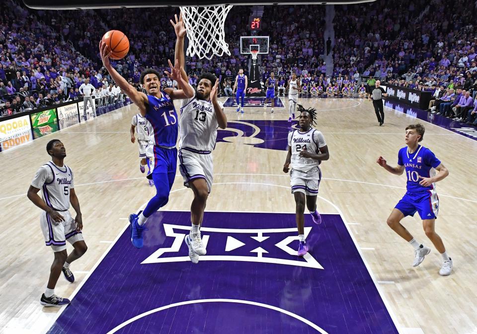 MANHATTAN, KS - FEBRUARY 05: Kevin McCullar Jr. #15 of the Kansas Jayhawks goes to the basket against Will McNair Jr. #13 of the Kansas State Wildcats in the second half at Bramlage Coliseum on February 05, 2024 in Manhattan, Kansas. (Photo by Peter Aiken/Getty Images)