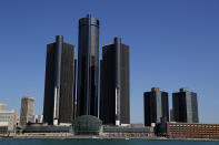 FILE - This May 12, 2020, file photo, shows a general view of the Renaissance Center, headquarters for General Motors, along the Detroit skyline from the Detroit River. General Motors will keep its headquarters in the sparsely populated seven-building office tower complex says CEO Mary Barra. (AP Photo/Paul Sancya)