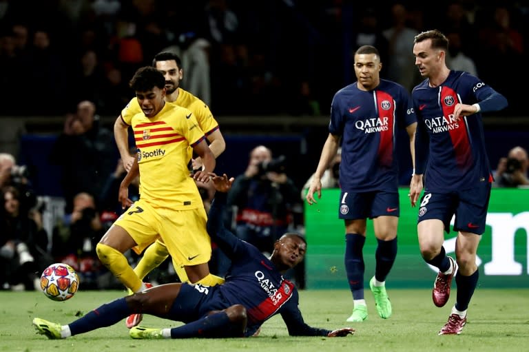 Lamine Yamal (L) became the youngest player ever to feature in the Champions League quarter-finals (Anne-Christine POUJOULAT)