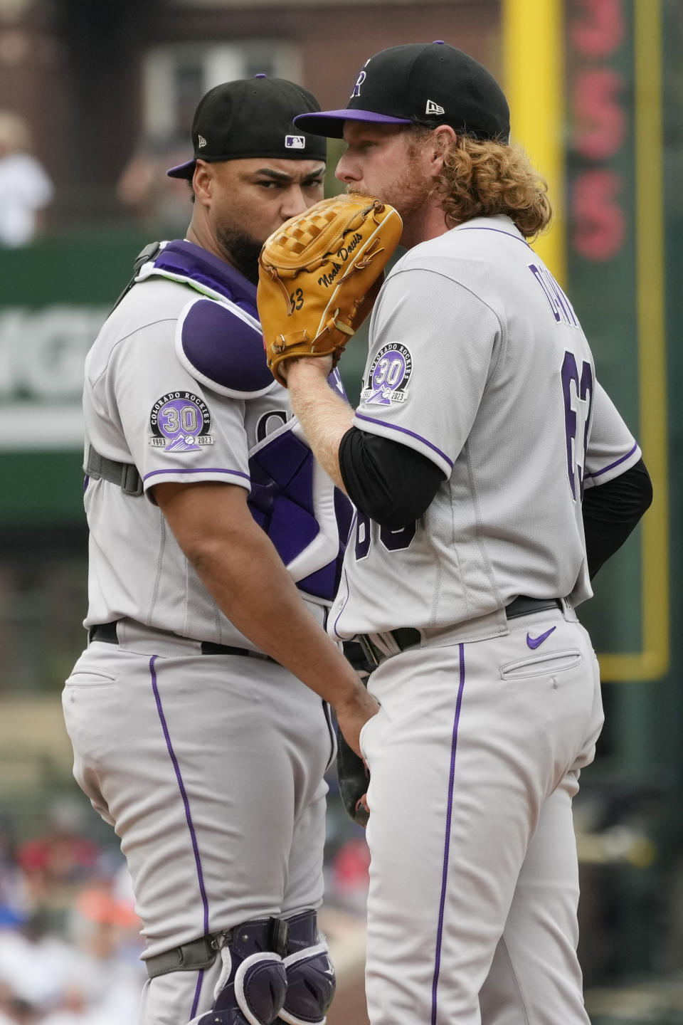 Colorado Rockies starting pitcher Noah Davis, right, listens to catcher Elias Diaz during the first inning of a baseball game against the Chicago Cubs in Chicago, Friday, Sept. 22, 2023. (AP Photo/Nam Y. Huh)