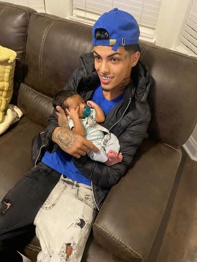 Sean Yadriel Burgos-Jimenez holds his 4-month-old son. Burgos-Jimenez was shot and killed in the parking lot of the Fort Walton Beach Recreation Center on July 7.