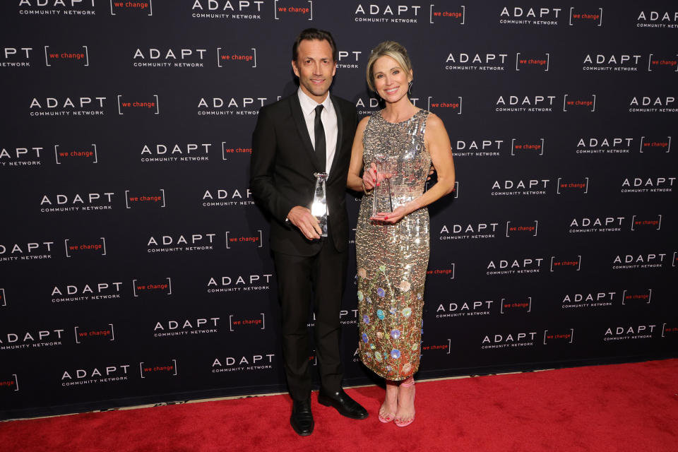 2022 ADAPT Leadership Award honourees Andrew Shue and Amy Robach pose together with their awards