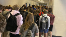 CORRECTS SPELLING OF LAST NAME TO WATTERS, NOT WATERS - FILE - In this photo posted on Twitter, students crowd a hallway, Tuesday, Aug. 4, 2020, at North Paulding High School in Dallas, Ga. The Georgia high school student says she has been suspended for five days because of photos of crowded conditions that she provided to The Associated Press and other news organizations. Hannah Watters, a 15-year-old sophomore at North Paulding High School, says she and her family view the suspension as overly harsh and are appealing it. (Twitter via AP, File)