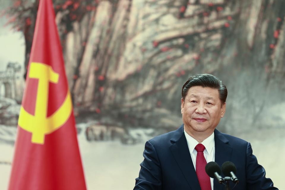 Chinese President Xi Jinping speaks at the podium during the unveiling of the Communist Party's new Politburo Standing Committee at the Great Hall of the People on October 25, 2017 in Beijing, China.