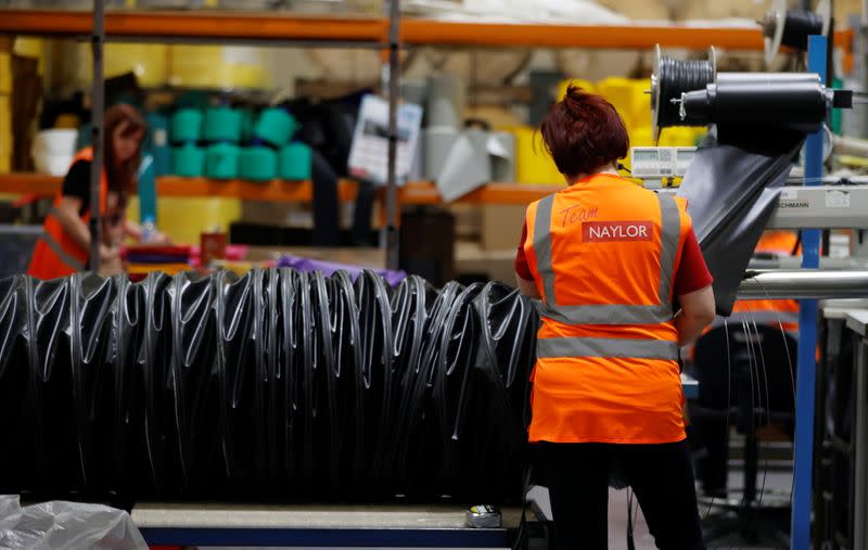 A worker constructs a length of ducting tube inside the Naylor Industries Wombwell site in Wombwell