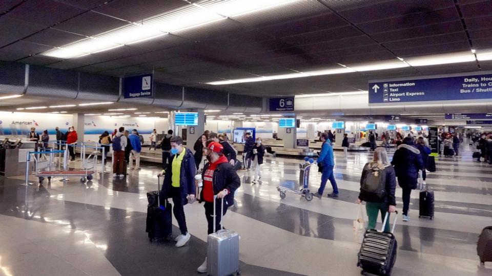 PHOTO: Travelers collect their luggage at baggage claim after arriving at O'Hare International Airport on March 11, 2022 in Chicago, Illinois. (Scott Olson/Getty Images)