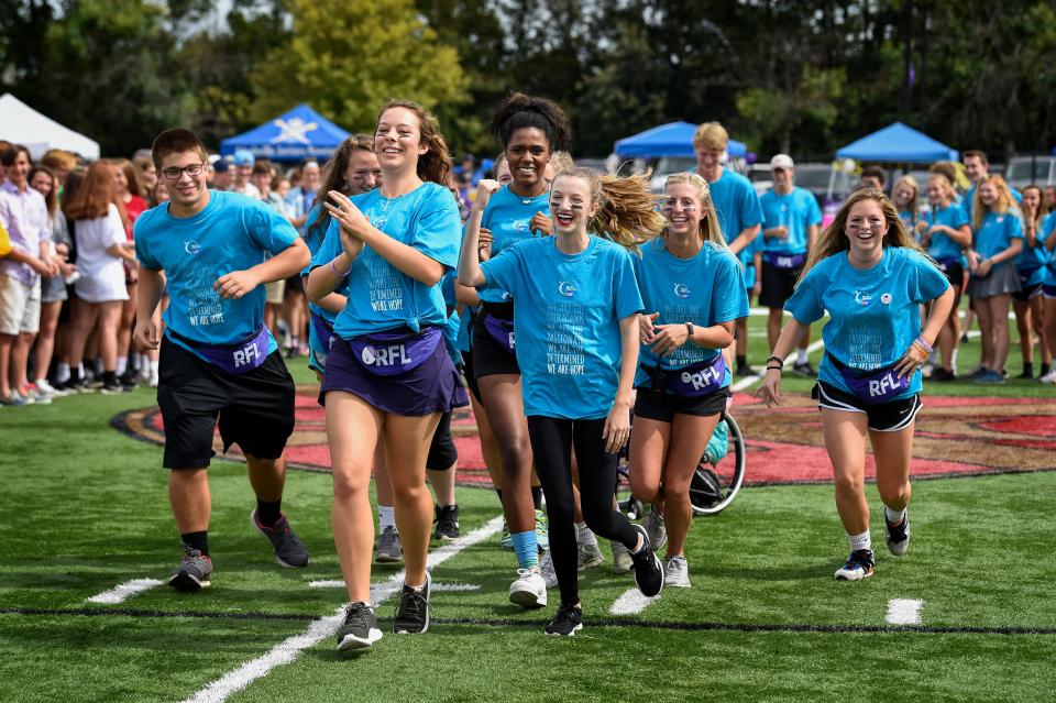 Students volunteers join the cancer survivors, fighters in the opening ceremonies of the Relay for Life fundraiser for the American Cancer Society in the Giacosa Stadium at the Father Ryan High School in Nashville, Tenn., Saturday, Sept. 30, 2017.