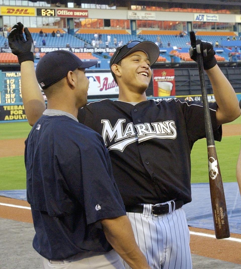 Florida Marlins' Miguel Cabrera jokes with New York Yankees' Juan Rivera prior to during game 4 of the World Series at Pro Player Stadium in Miami, Fla., Wednesday Oct. 22, 2003.