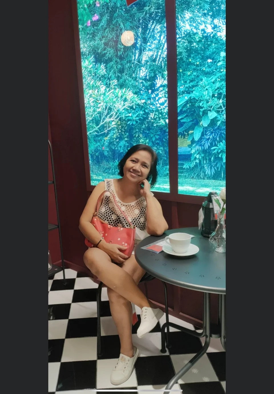 Former helper Janet Remia Aclon Peremne sits in a cafe in Manila