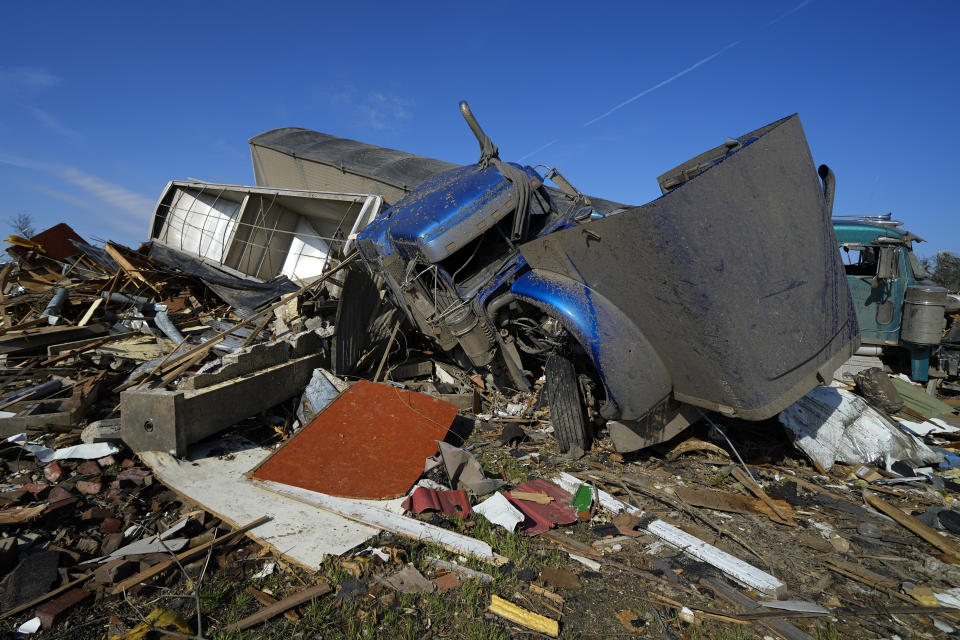 Two semis are seen bunched up, Sunday, March 26, 2023, in Rolling Fork, Miss., after they were moved by a tornado two days earlier. Emergency officials in Mississippi say several people have been killed by tornadoes that tore through the state on Friday night, destroying buildings and knocking out power as severe weather produced hail the size of golf balls moved through several southern states. (AP Photo/Julio Cortez)