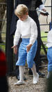 <p>Prince George looked adorable in a pair of blue trousers, white tights, white shoes and a matching white shirt. Photo: Australscope </p>