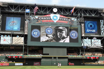 <b>The scoreboard at Chase Field dwarfs players and fans alike. This photo was taken on April 15, 2009, in a game against the St. Louis Cardinals.</b> Christian Petersen/<a class="link " href="http://www.gettyimages.com" rel="nofollow noopener" target="_blank" data-ylk="slk:Getty Images;elm:context_link;itc:0;sec:content-canvas">Getty Images</a>