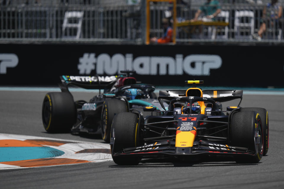 Red Bull driver Sergio Perez of Mexico steers his car in front of Mercedes driver George Russell of Britain during the practice session for the Formula One Miami Grand Prix auto race, Friday, May 3, 2024, in Miami. (AP Photo/Rebecca Blackwell)