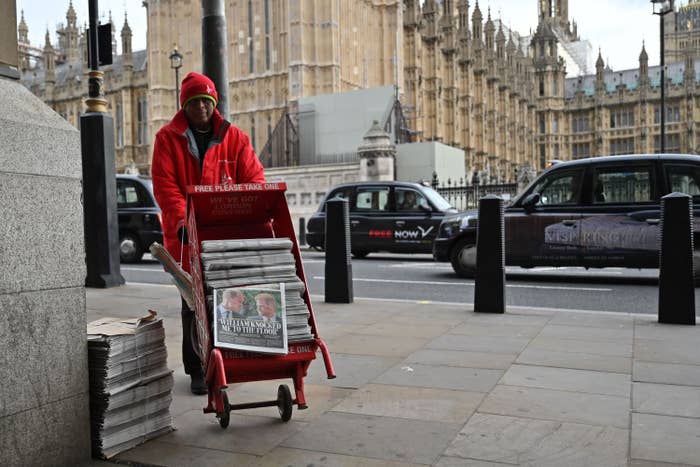 Someone rolling out newspapers