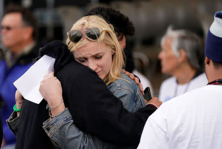 Emmy Adams hugs another student as teens kick off a voter registration rally, a day ahead of the 19th anniversary of the massacre at Columbine High School, in Littleton, Colorado, U.S., April 19, 2018. REUTERS/Rick Wilking