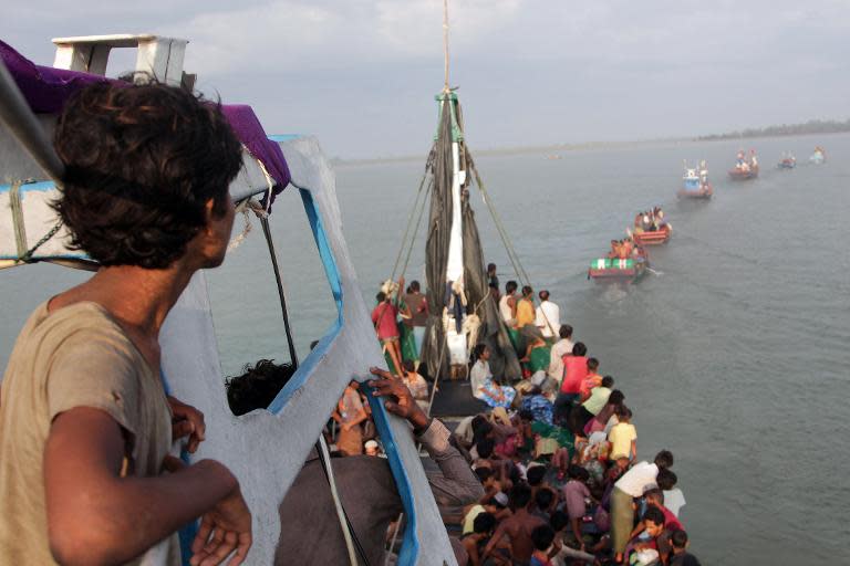 Acehnese fishing boats help rescue Rohingya migrants off the coast of Indonesia's Aceh province on May 20, 2015