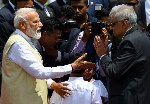 Sri Lankan Prime Minister Ranil Wickremesinghe (right) welcomes Indian Prime Minister Narendra Modi at Bandaranaike International Airport in Katunayake