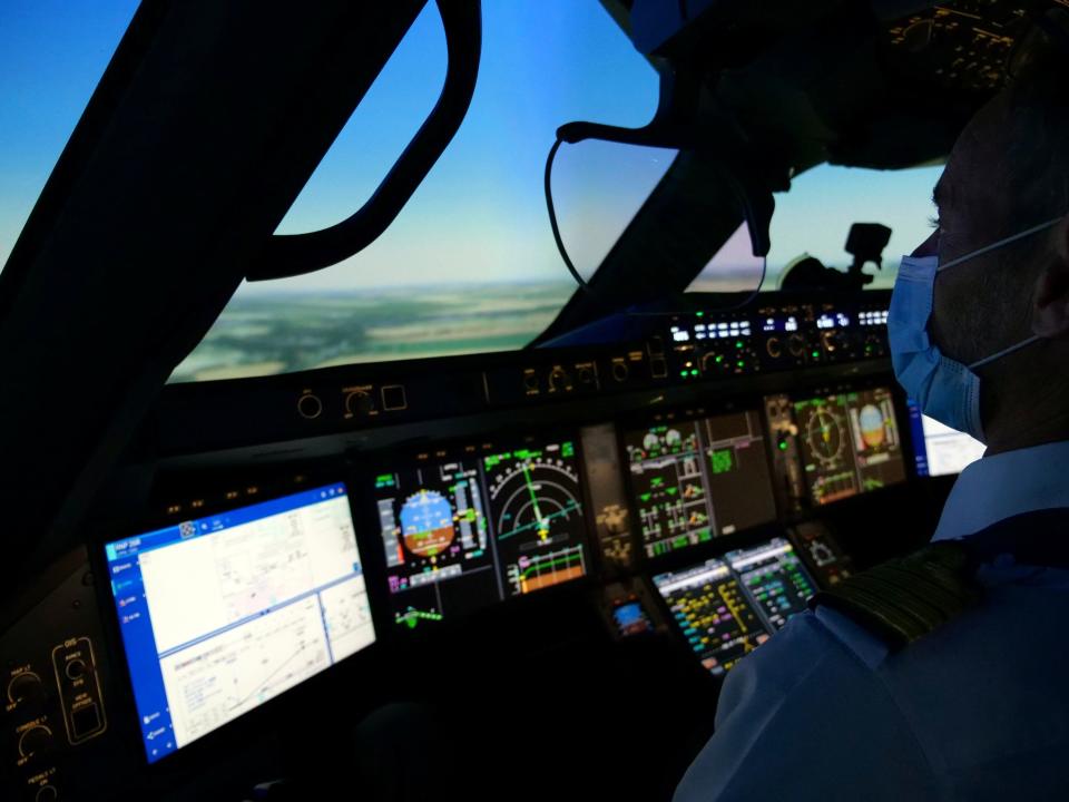 An Air France pilot wearing a protective mask trains in an Airbus A350 flight simulator at an Air France training centre near Charles de Gaulle airport as European safety rules require extra training for any pilot that has not carried out at least three take-offs and landings over the last three months, amid the coronavirus disease (COVID-19) outbreak near Paris, France, May 15, 2020. REUTERS/Noemie Olive