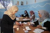 A woman dips her finger in a bottle of ink before voting in the municipal election at a polling station in Benghazi April 19, 2014. REUTERS/Esam Omran Al-Fetori