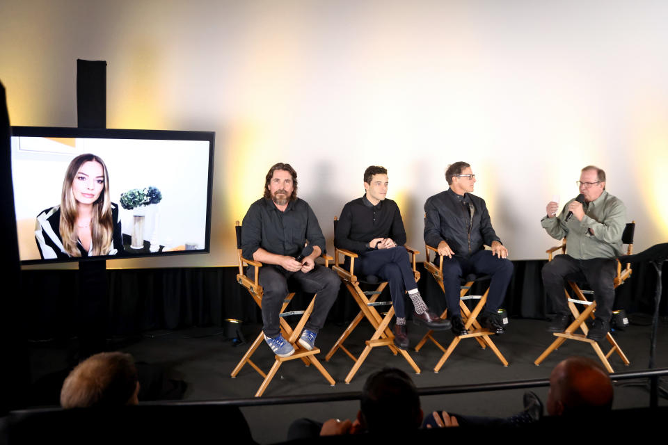 (L-R) Margot Robbie (onscreen), Christian Bale, Rami Malek, David O. Russell and Deadline’s Pete Hammond at an Imax event in September