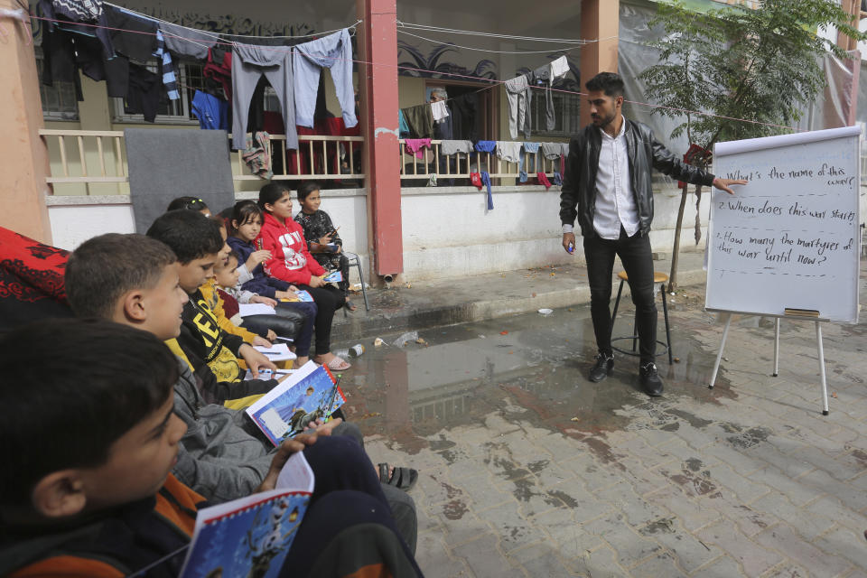 English teacher Tariq Al-Annabi holds a class in a UN-run school in Rafah, Gaza Strip, on Sunday, Nov. 26, 2023, on the third day of a temporary ceasefire between Hamas and Israel. (AP Photo/Hatem Ali)
