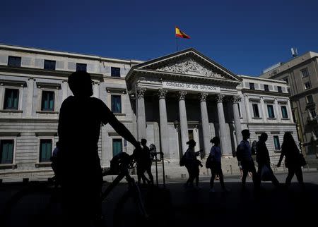 People walk past Spain's parliament in Madrid, Spain, August 28, 2016. REUTERS/Andrea Comas