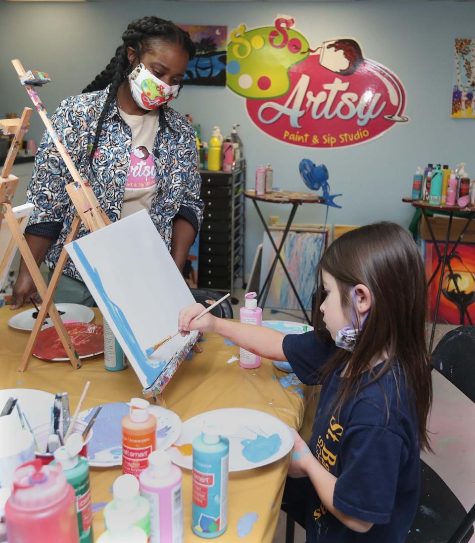 Melinda Turner, owner of So So Artsy Paint and Sip Studio works with student Ali DiPaola, 5, during a one-on-one art session at the studio in Northfield.