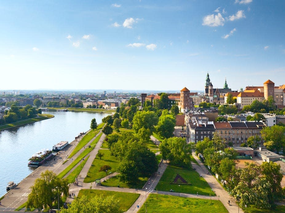 Kraków, Poland with views of the Vistula River and Wawel Castle.