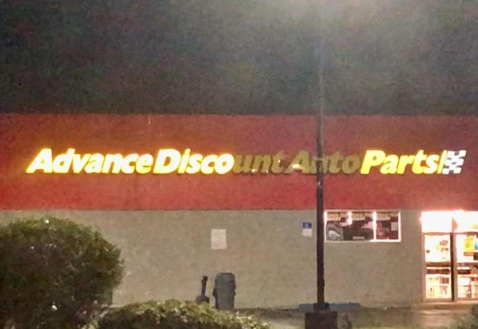 Storefront sign for "Advance Discount Auto Parts" reads "advance disco parts"