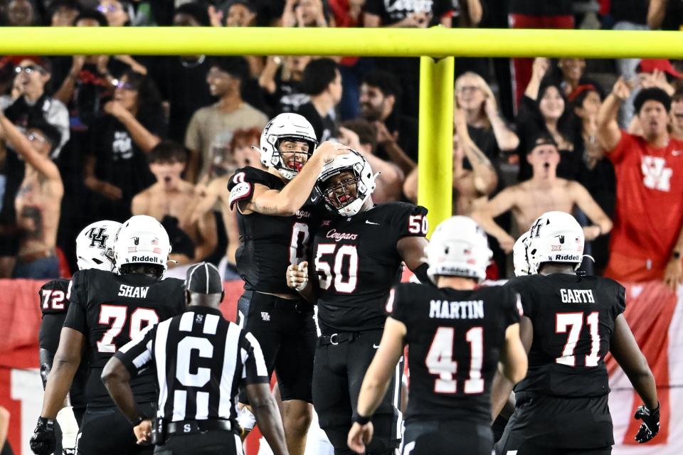 Houston wide receiver Joseph Manjack IV, left, celebrates a touchdown with offensive lineman Tyler Johnson against West Virginia last week at TDECU Stadium in Houston. The Cougars will look for a second straight Big 12 win Saturday against Texas.