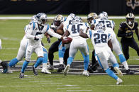Carolina Panthers quarterback Teddy Bridgewater (5) hands off to running back Mike Davis (28) in the first half of an NFL football game against the Carolina Panthers in New Orleans, Sunday, Oct. 25, 2020. (AP Photo/Butch Dill)