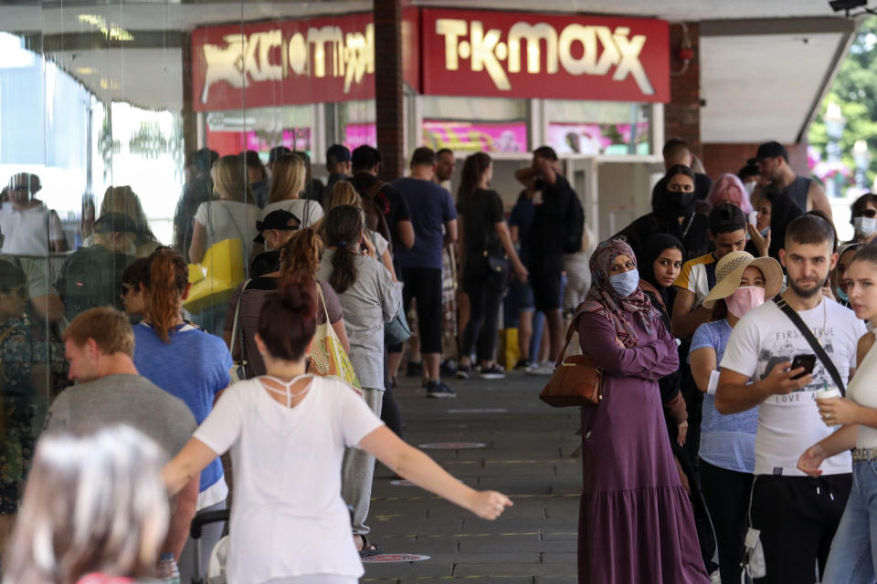 Shoppers queue outside TK Maxx in Kingston, south London, as non-essential shops in England reopened on Monday.