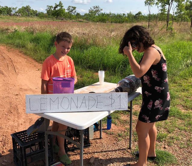 Andrew Jazyschyn, 10, serves a thirsty customer outside his family's home in the Northern Territory. Source: Philip Jazyschyn