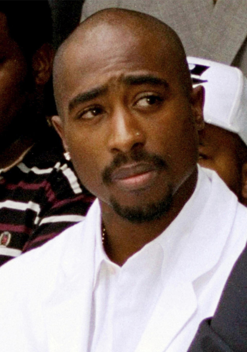 FILE - Rapper Tupac Shakur attends a voter registration event in South Central Los Angeles, Aug. 15, 1996. Shakur’s shooting in a New York recording studio in the mid-1990s sparked hip-hop’s biggest rivalry and led to the shocking deaths of two of the genre's greatest stars, Shakur, and Notorious B.I.G. Nearly three decades later, the recent arrest of longtime suspect Duane “Keffe D” Davis has ignited another wave of intrigue in their unsolved murders. (AP Photo/Frank Wiese, File)