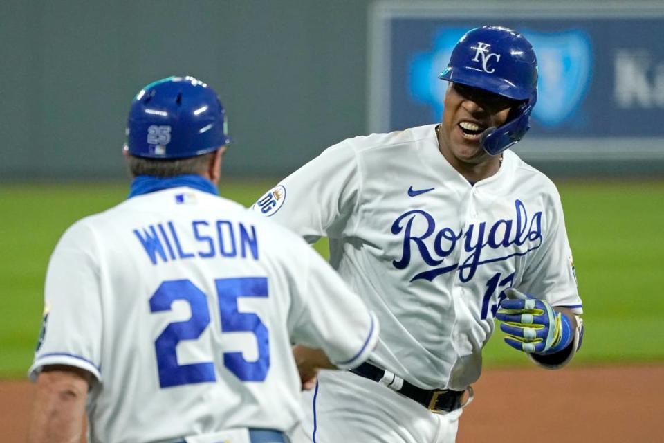 Kansas City Royals’ Salvador Perez celebrates with third base coach Vance Wilson after hitting a three-run home run during the first inning of the team’s baseball game against the Detroit Tigers on Thursday, Sept. 24, 2020, in Kansas City, Mo. (AP Photo/Charlie Riedel)